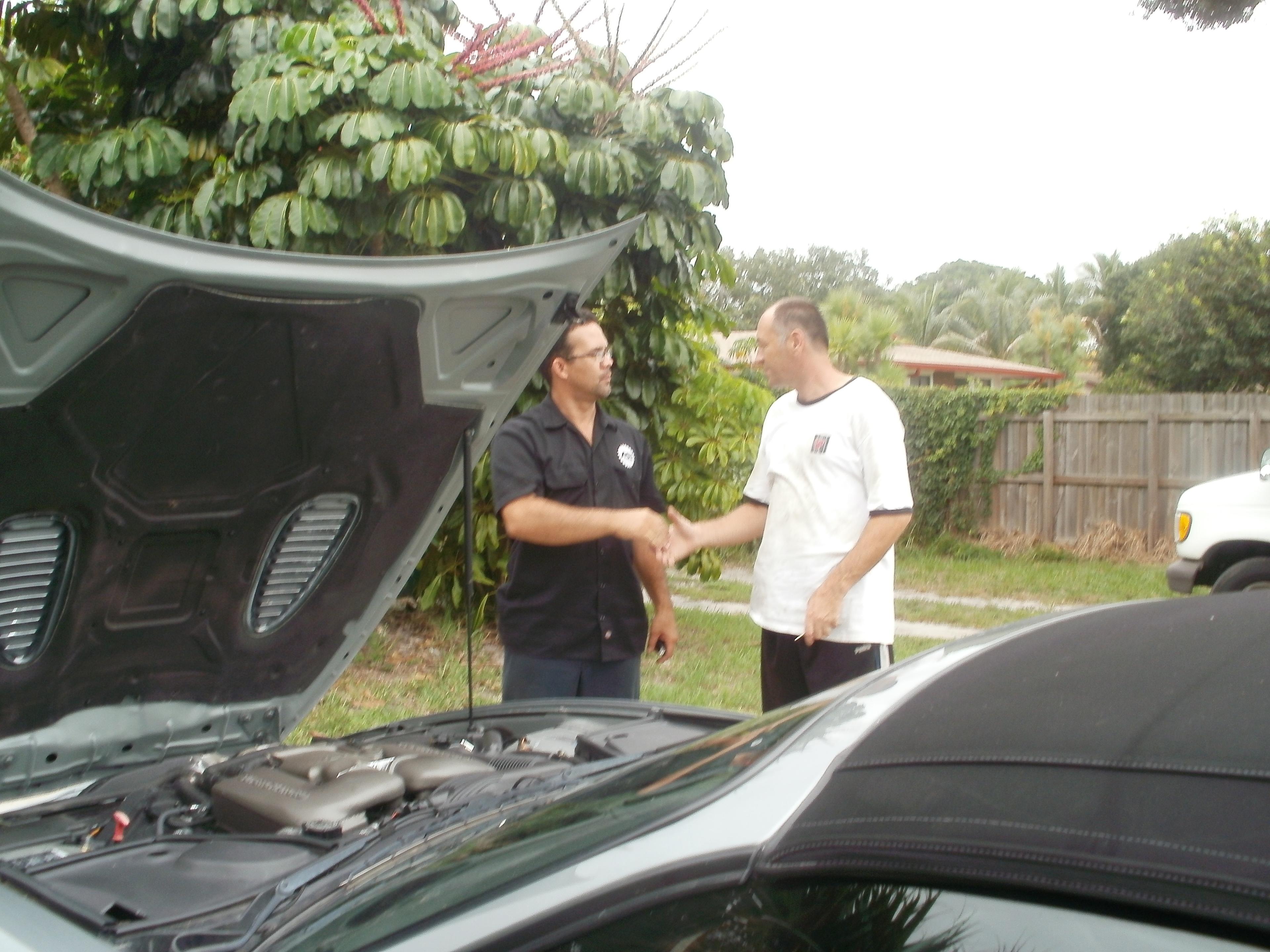 Pedro Inspecting a car.