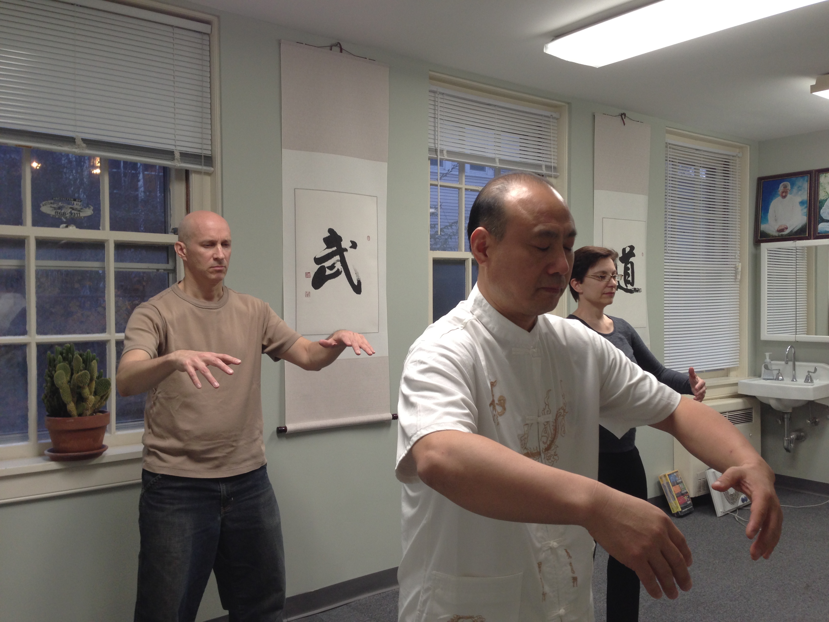 Master Wang leading Qigong practice, Qigong is an ancient Chinese physical exercise focusing on cultivating internal energy.