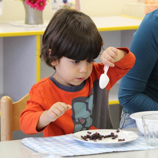 toddler learning life skills - serving snack