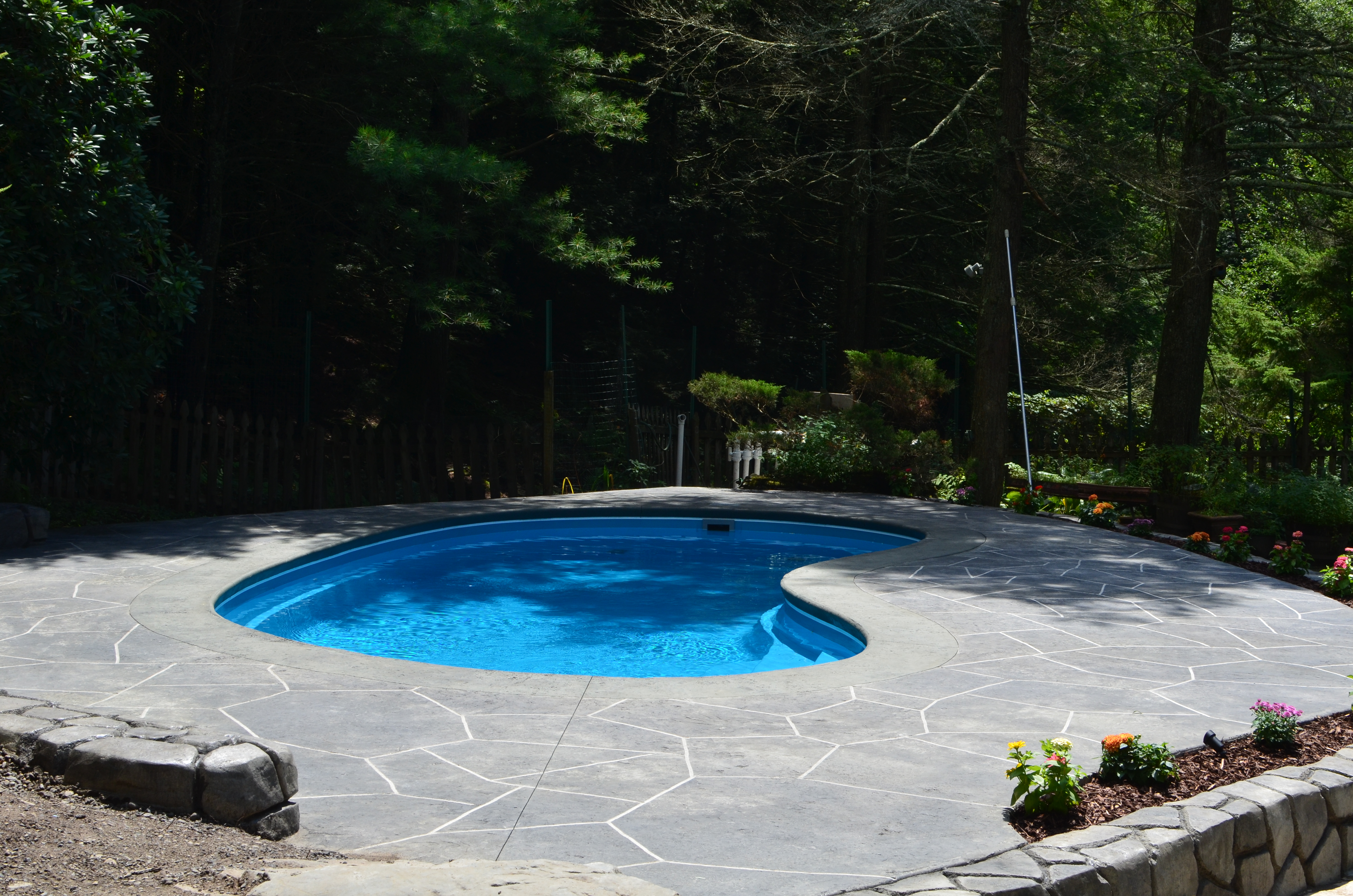 Fiberglass Swimming pool and StoneMakers concrete retaining walls and patio