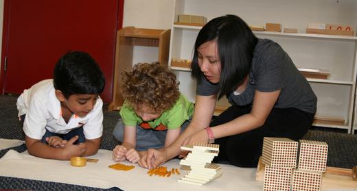 Montessori guide giving math lesson in preschool