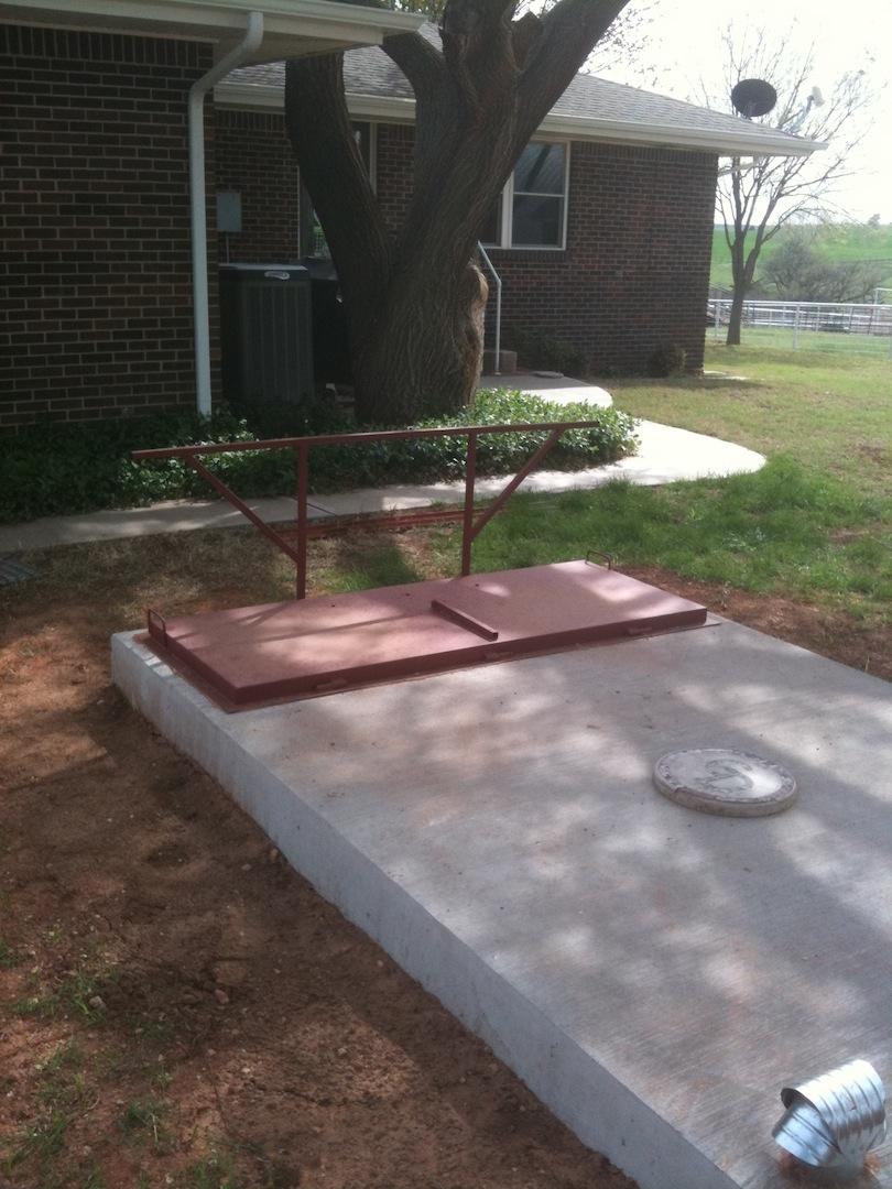 Flat Top storm shelter shown with outside hand rail.