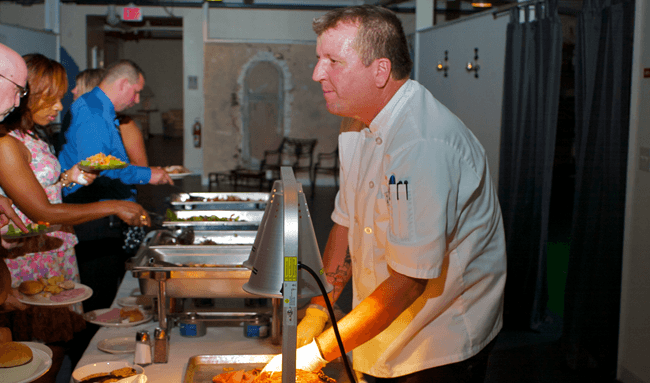 Our Head Chef working the carving station during a wedding reception.