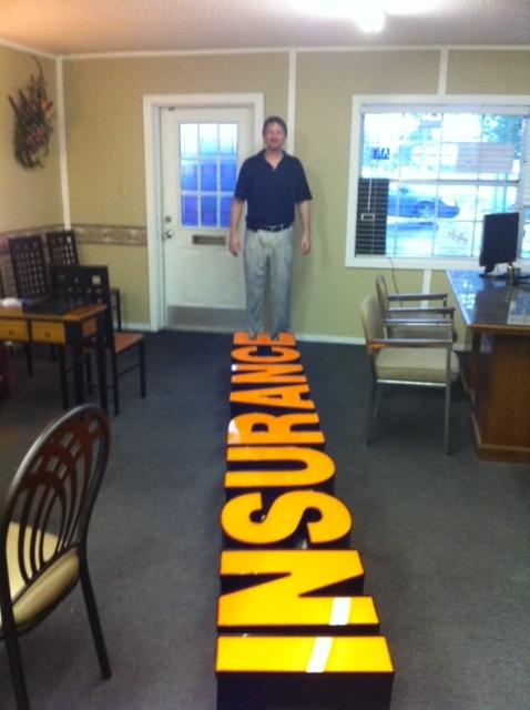 Manager Steve Green installing new sign.