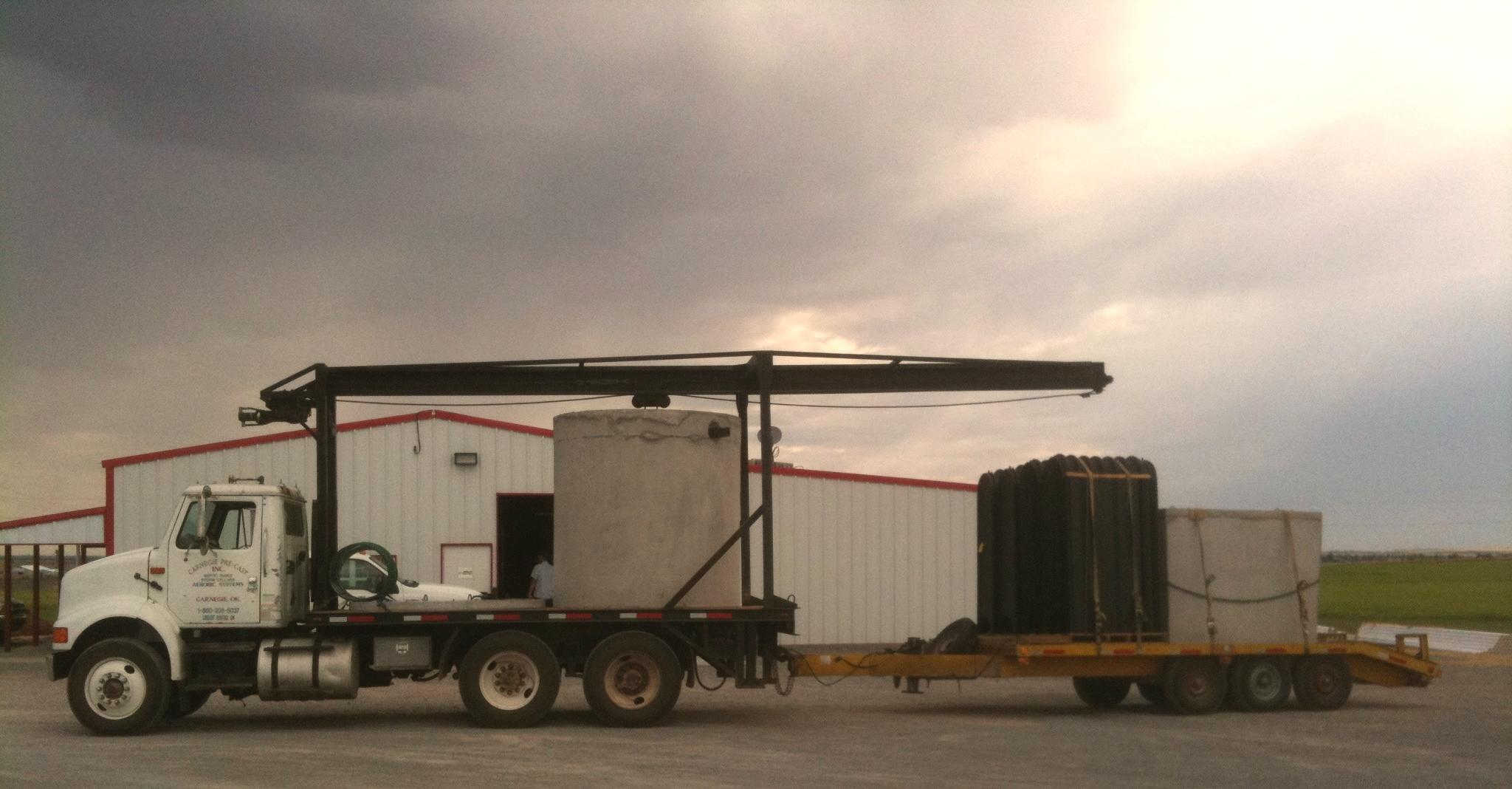 Loaded for delivery of a 1500 gallon special order septic tank, trailer has Chambers and a 443 gallon grease trap.