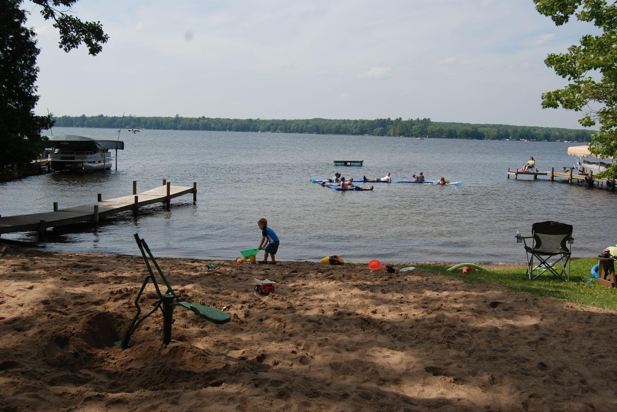 Enjoying the beach & playground at Weaver's Resort & Campground, Pelican Lake, WI