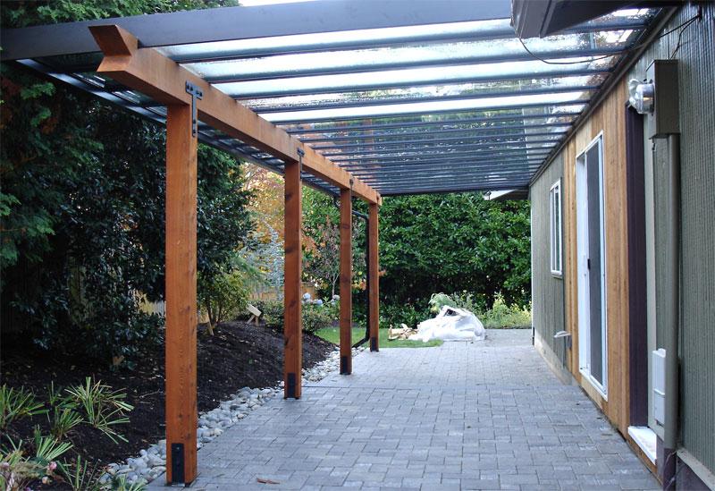 Black aluminum patio cover with glass infill and wood