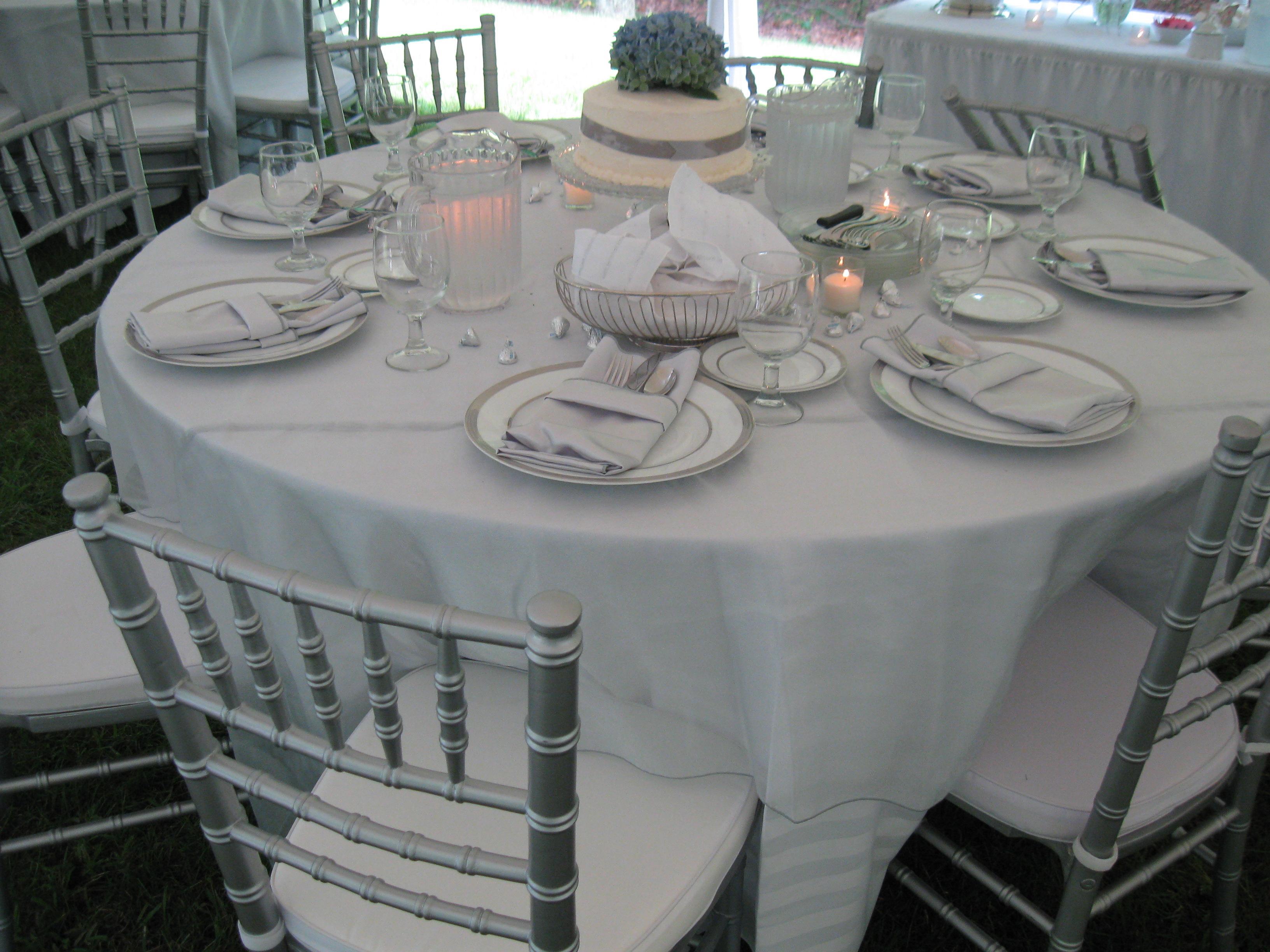 Chiavari silver chairs and white place settings.