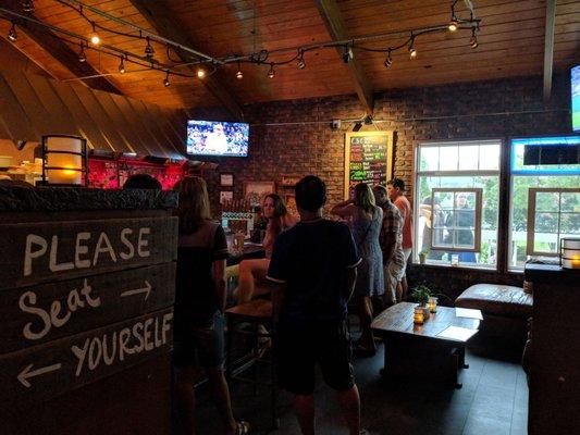 Bar area with a couple flat screens.