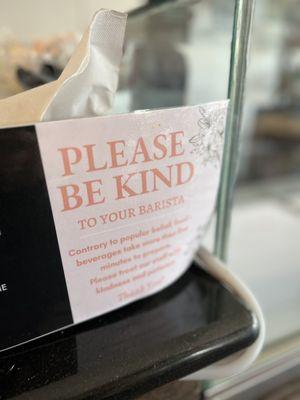 Sign asking for kindness to the baristas.