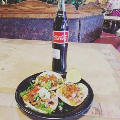 Tacos made of carnitas, chicken, and pickled pork skin with plenty of salsa