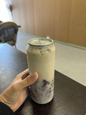 Jasmine milk tea with ube and boba sealed with a can top