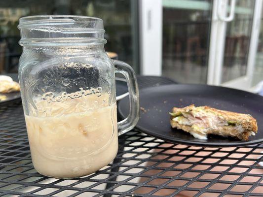 Iced chai latte and turkey, cheddar and avocado on multigrain