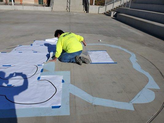 Working on school's logo in Riverside. www.stencilsus.com