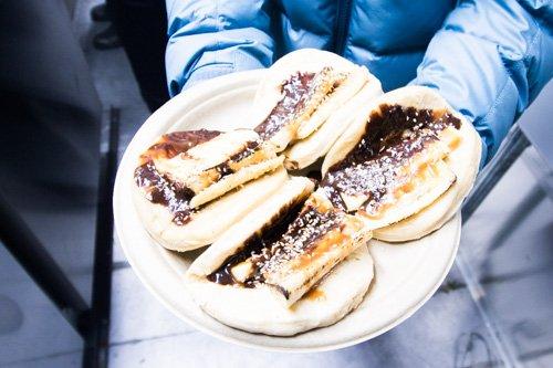 Caramelized bananas, Thai chili chocolate sauce, drizzled with palm sugar sesame seed caramel, and served in an open steam bun!