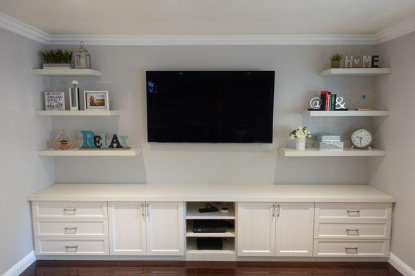 Our custom cabinets for the family room, plus floating shelves