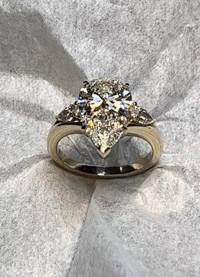 Pear shaped diamond engagement ring with pear shaped side diamonds