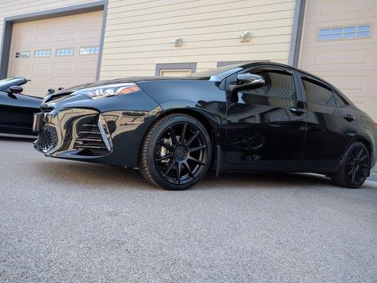 New rims and tires sitting on Toyota Racing Development Lowering Springs.