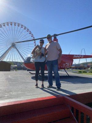 My husband, myself and Biggie, my service dog by the helicopter