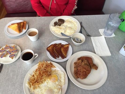 Breakfast; pork chops, eggs, hash browns and toast...eggs, rice, sausage and toast