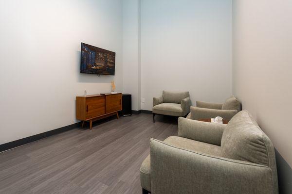 Exam room at Vertrae® with sofa chairs and television