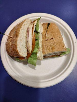 Cajun chicken sandwich with lettuce tomato red onion and roasted garlic mayonnaise