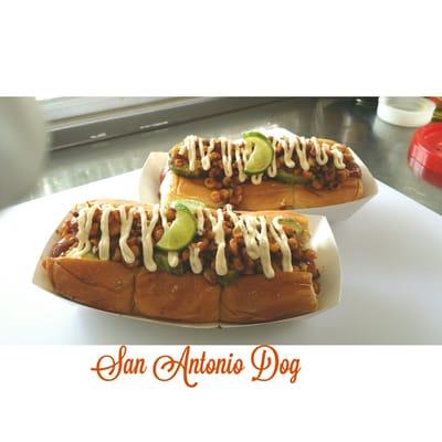 Hebrew National Dog grilled & placed in a Toasted Kings Hawaiian Bun, topped w/ Guacamole, Seasoned Grilled Corn & drizzled with Lime Crema