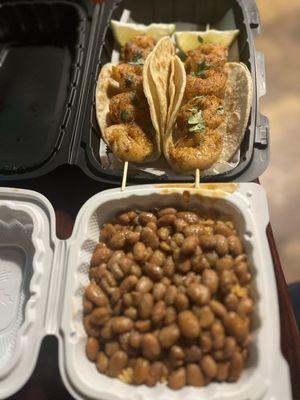 Beans and rice and skewer shrimp tacos