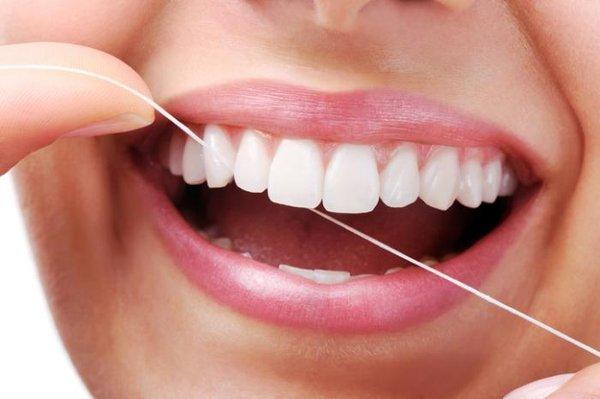 Flossing between teeth removes plaque that can lead to cavities or gum disease from the areas where a toothbrush can't reach.