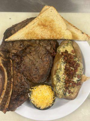 Grilled ribeye steak, loaded bake potato and garlic toast