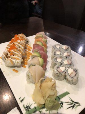 Shrimp tempura roll, rainbow roll and on right, Philadelphia roll.