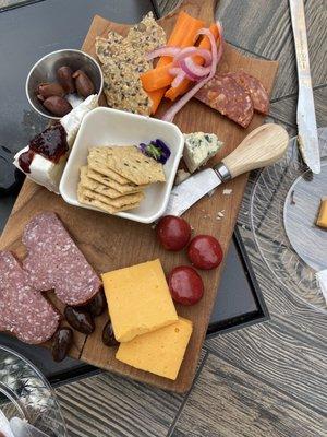 Charcuterie tray, Kalamata olives, salami, smoked cheddar, Brie, chocolate almonds, pickled onions, very tasty.