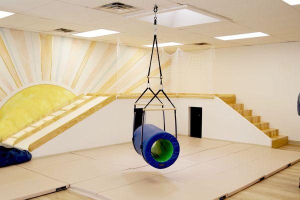 Interactive therapy gym designed for pediatrics. Stairs that lead to slide, under stairs hideout, swing and mats.