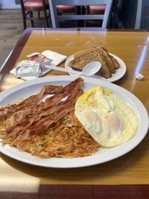 3 eggs over easy.  Bacon and hash browns and wheat toast