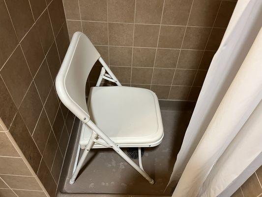 Staff didn't know what a proper shower chair is, so grabbed a folding metal chair!!