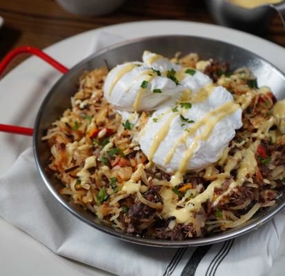 Short Rib Hash: braised short ribs, crispy potatoes, red & yellow peppers, poached eggs, hollandaise