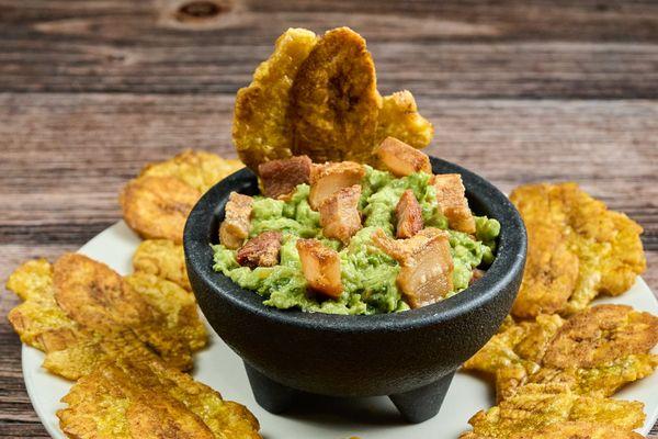 The perfect combo! Creamy guacamole, crispy pork crackling, and golden tostones. A flavor explosion you won't want to miss.