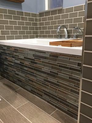 Gorgeous glass tile for front of tub. Subway tile and all grout from tile outlet. (Floor tile from another retail place(