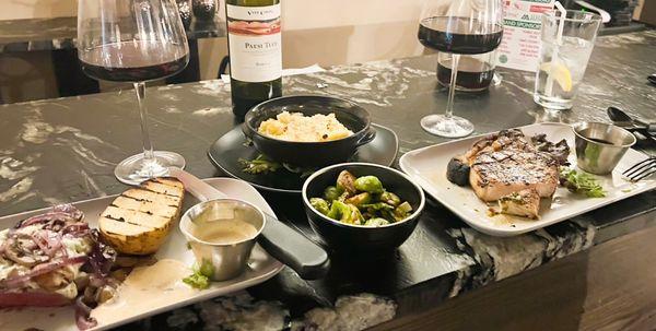 Fillet with blue cheese, roasted potato, brussels sprouts, mac n cheese, and pork chop with chimichurri sauce.