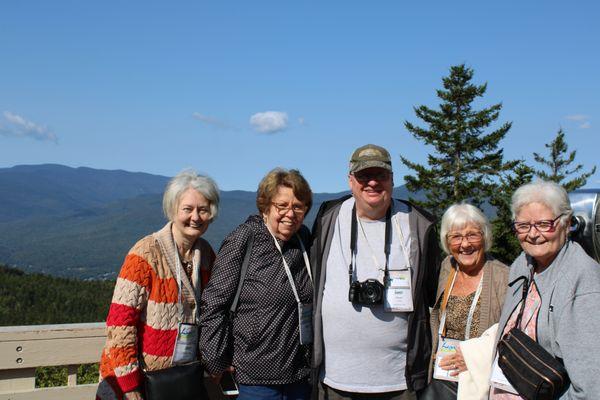 Some travelers at one of the many spectacular views on our Fall Foliage group tour.