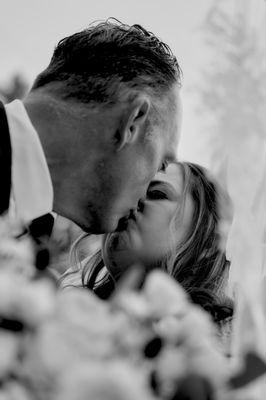 Bride and Groom Kissing - Photo by Alex Tapia