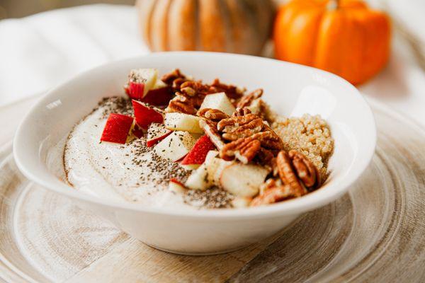 Fall, breakfast, warmed cinnamon quinoa, bowl, topped with yogurt, Chia seeds, apples, pecans