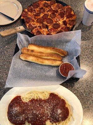 Spaghetti Bowl with breadsticks and a thin crust pepperoni pizza