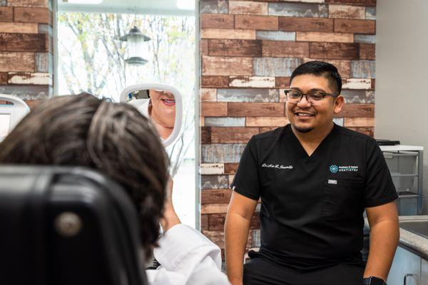 Dr. Jaramillo showing a patient their smile at Aesthetic & Implant Dentistry