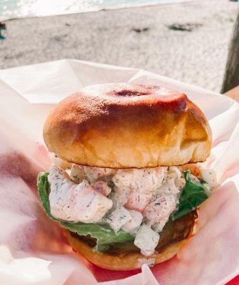 Savory and creamy shrimp salad sandwich with citrus notes on a pillowy brioche bun.