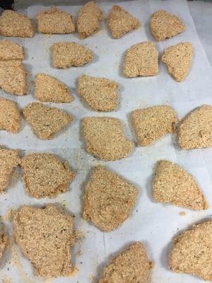 Hand breaded provolone triangles ready for the fryer