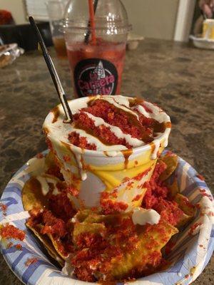 Elote Chorreado with Hot Cheetos dust on top.