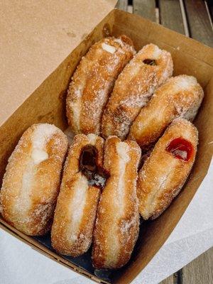 Original, custard filled, chocolate filled and raspberry filled malasadas