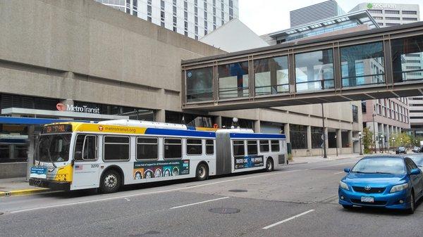 Buses augment the Metro system.  Here, one is at a stop under one of the many skybridges in St. Paul.