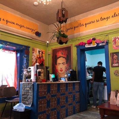 Painting of Frida Kahlo, colorful papel picado and artsy tiles decorate this vibrant cafe.